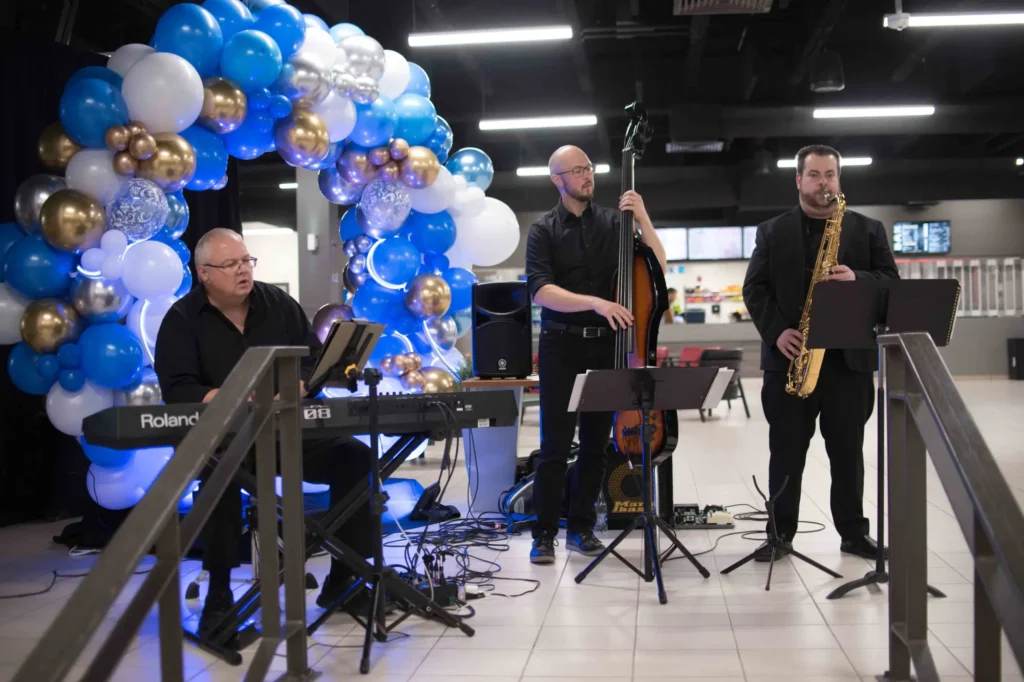 Trio de jazz sous arche de ballons bleus