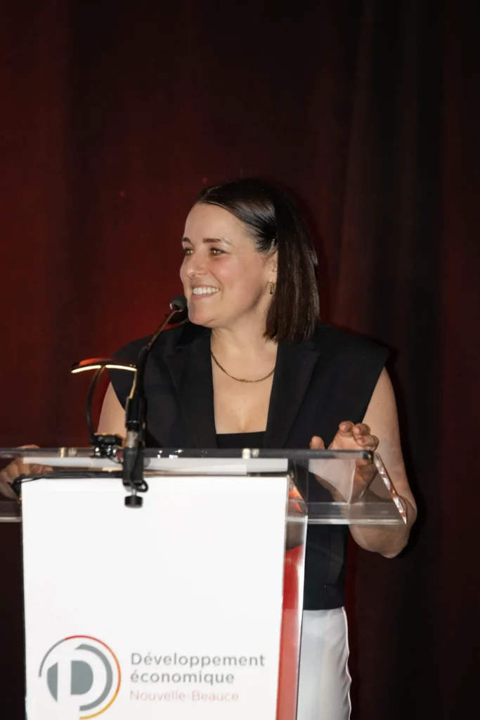Femme souriante au pupitre lors d’un discours