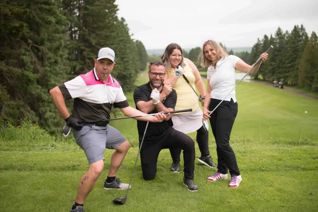 Quatre amis posant sur un parcours de golf